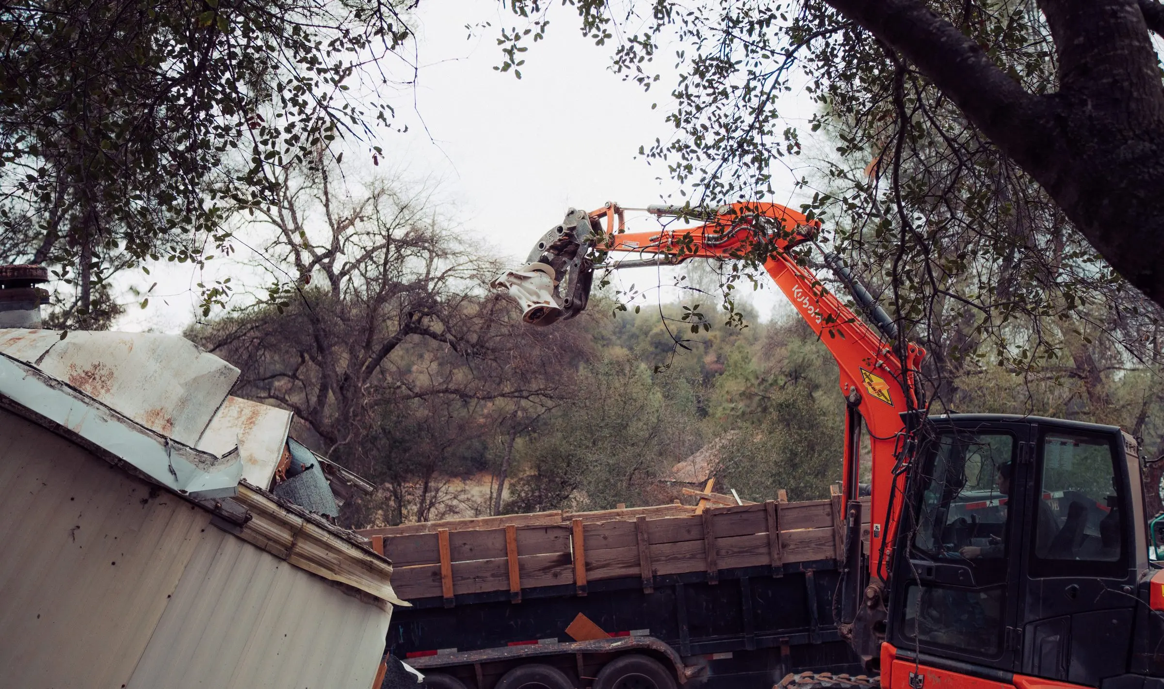 Excavator dropping debris into a dump trailer