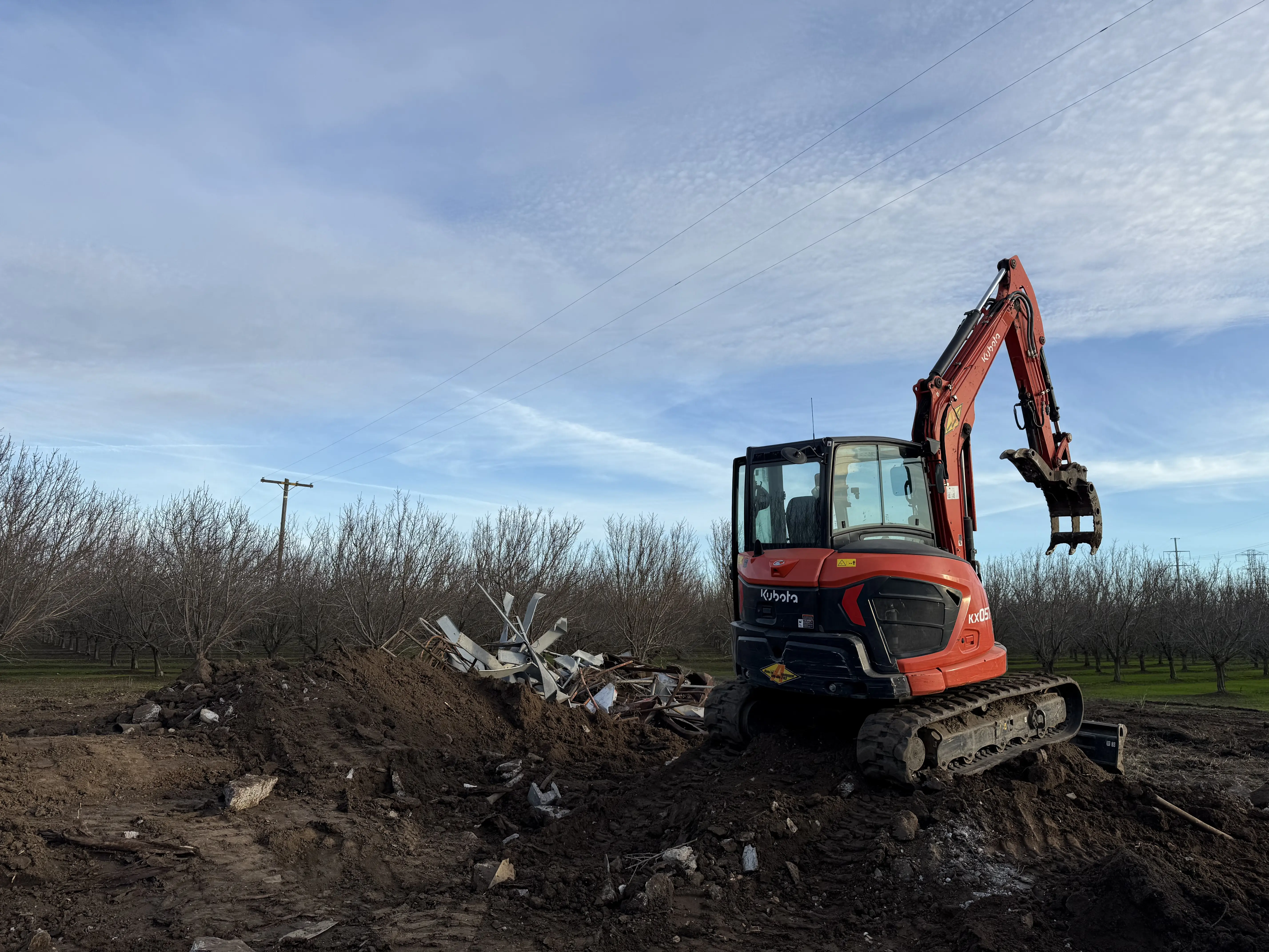 Kubota excavator on rural demolition job site