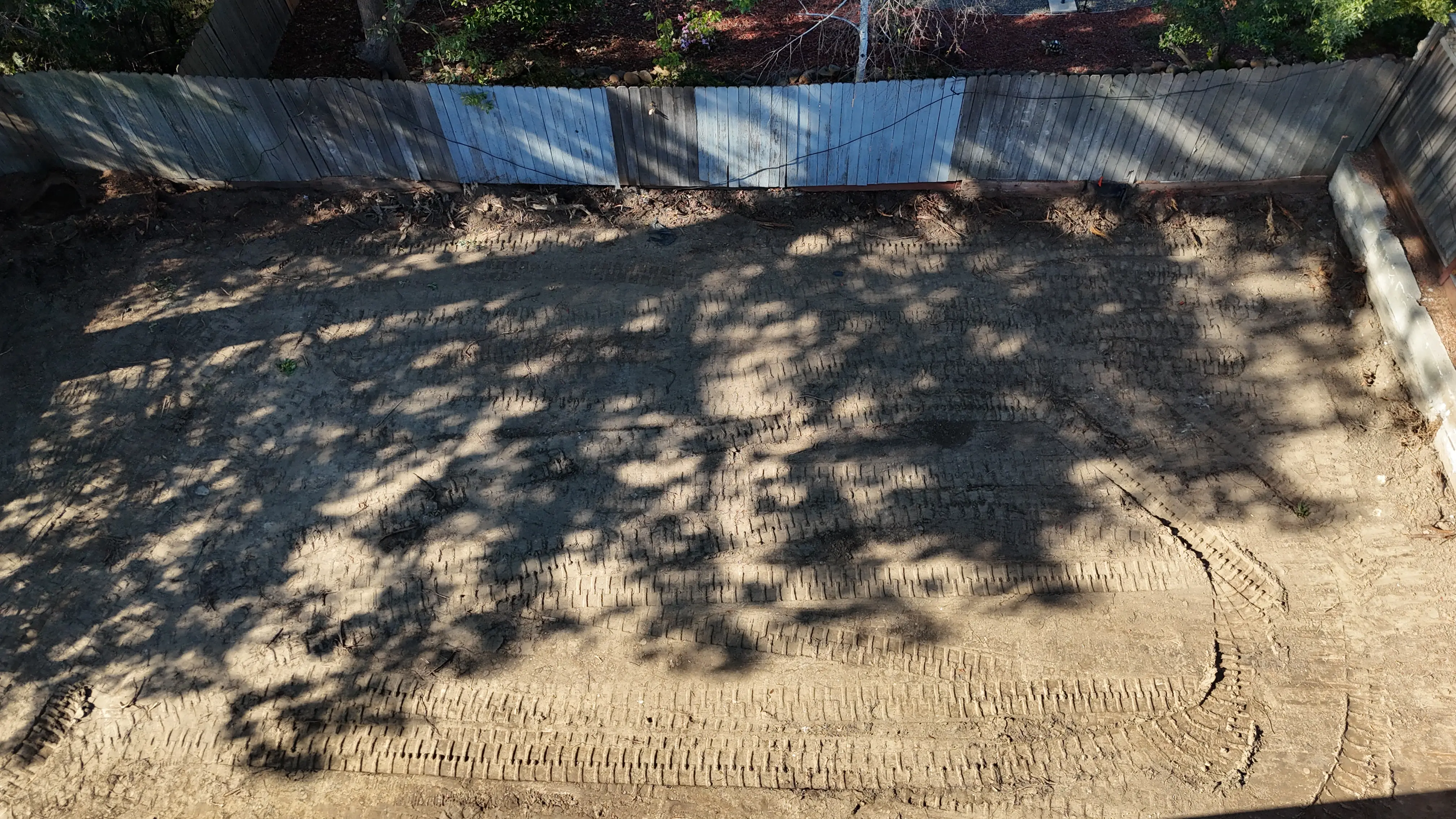 Aerial view of a cleared and graded lot after demolition, ready for the next trade