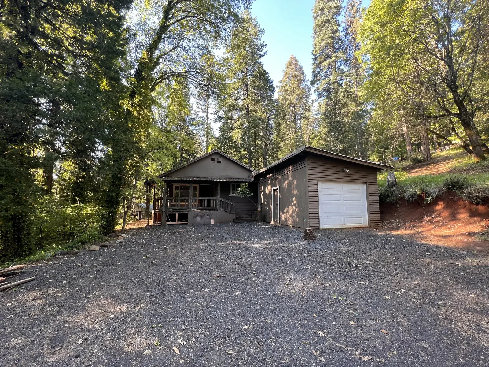 Fire-affected home on a wooded Magalia lot before demolition