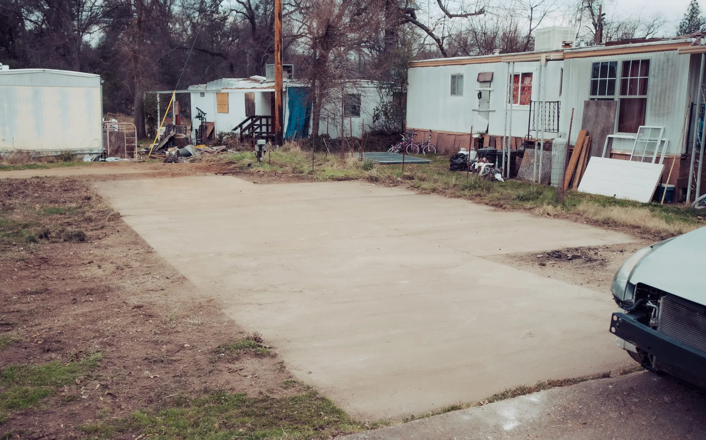 Empty concrete pad in a mobile home park after removal